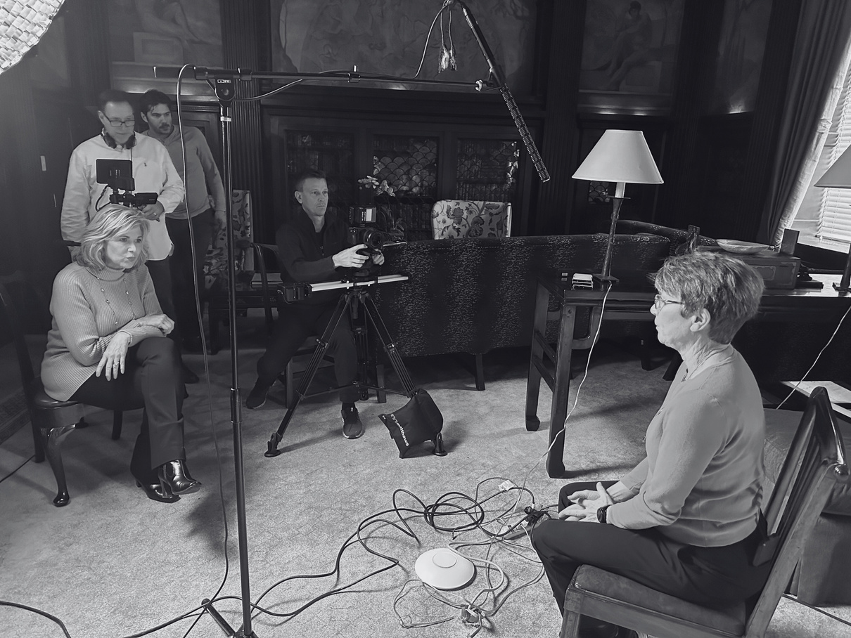 Journalist Marianne Banister, filmmakers Stanley Preston, Dan Poole, Tommy Duncan shooting an interview with investigative journalist Jane Miller on the set of filming Baltimore 100 Years.